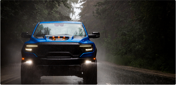 blue truck driving down road