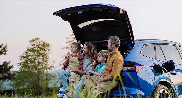 family sitting in back of car